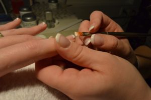 A person is getting their nails done