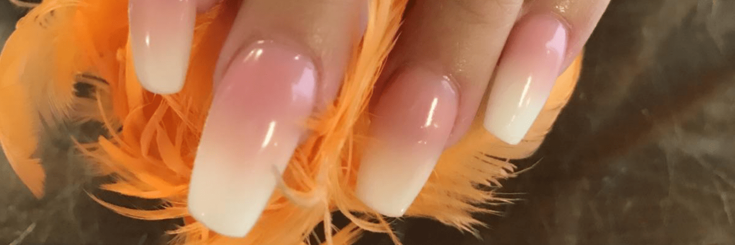 A close up of the nails and feathers on someones finger.